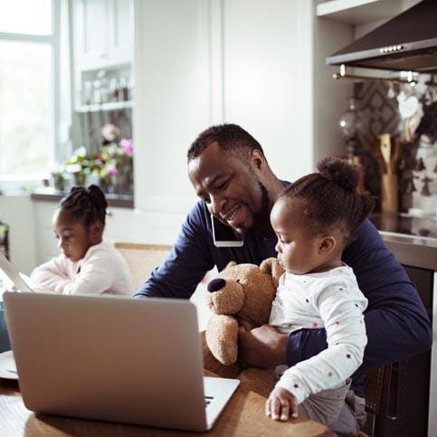 Small business owner working from home with their family